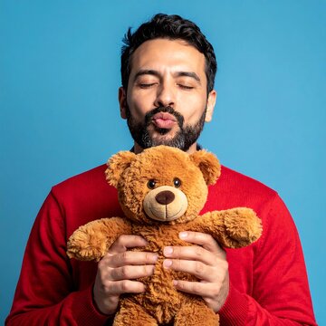 Man gives a kiss to a teddy bear