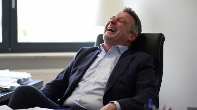 Joyful Businessman Laughing in Office