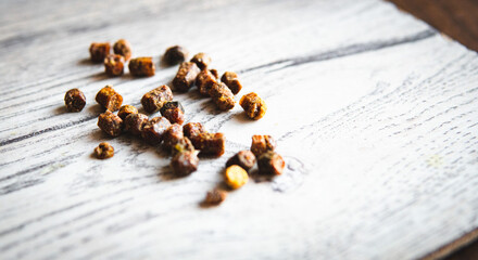 Bee Bread (Perga) Pellets Scattered on Wooden Board – Macro