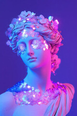 Naklejka premium Antique statue wearing sparkling sequins under colorful neon lights, creating a modern and glamorous artwork