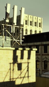 Rooftops display a blend of modern and historic architecture under cloudy skies. The silhouettes of structures create an interesting urban landscape, revealing city life above street level.