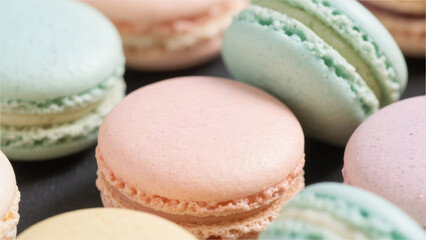 Obraz premium Pastel Macarons: A close-up image showcasing a delicious assortment of pastel-colored macarons. Each delicate treat, with its perfect shape and inviting color.