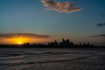 Early morning sunrise over the Liverpool skyline viewed across the River Mersey