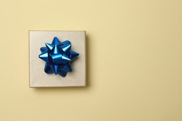 Elegant bright gift box on color surface