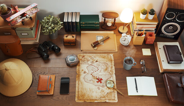 Vintage style explorer desktop with travel equipment and treasure map - Powered by Adobe