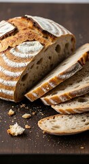 Sliced Artisan Bread on Dark Wooden Board.