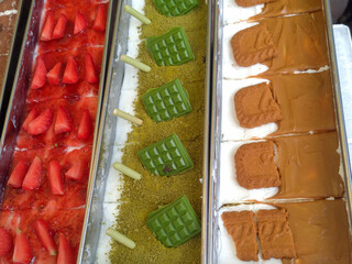 Assorted cheesecake desserts with strawberry, matcha, and Biscoff toppings