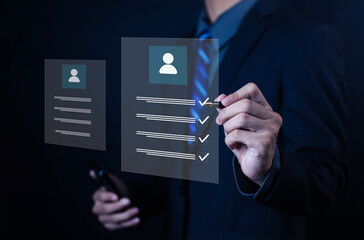 Businessman using digital pen to check virtual profile checklist, concept for human resources management, employee evaluation, recruitment, data analysis, and business technology innovation.
