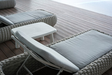 Wicker Loungers and Table on Wooden Deck