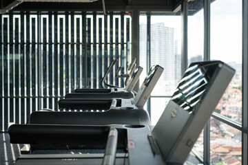 Row of Treadmills in a Gym with City View