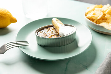 Canned cockles served on turquoise dish with appetizers
