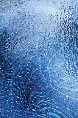 Blue ice rippled surface. Frozen transparent matte glass texture	