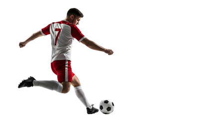 Soccer player in action kicking a ball with determination.