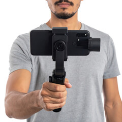 Person holds a smartphone mounted on a gimbal stabilizer, facing forward