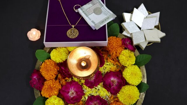 Elegant festive present box containing ornaments and currency symbolizing prosperity