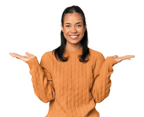 Naklejka na ściany i meble Young Filipina woman makes scale with arms, feels happy and confident. Naklejka na ściany i meble Young Filipina woman makes scale with arms, feels happy and confident.