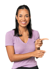 Young Filipina woman excited pointing with forefingers away.