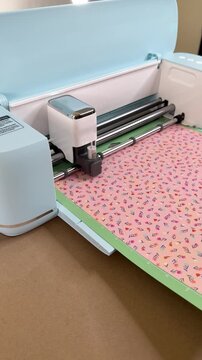 Cutting plotter cutting shapes from colorful paper