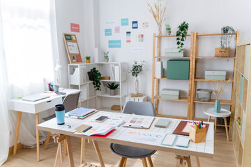 Modern creative home office workspace with plants and organized shelves