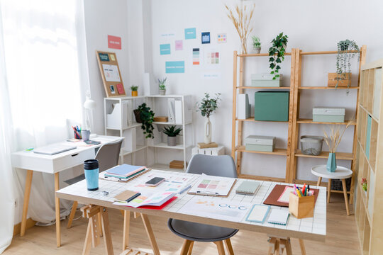Modern creative home office workspace with plants and organized shelves