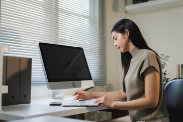 Fototapeta premium Woman working at home office desk checking document