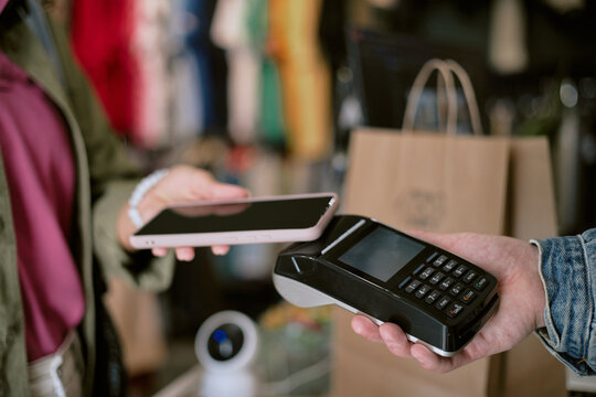 Contactless payment with smartphone at retail store checkout counter