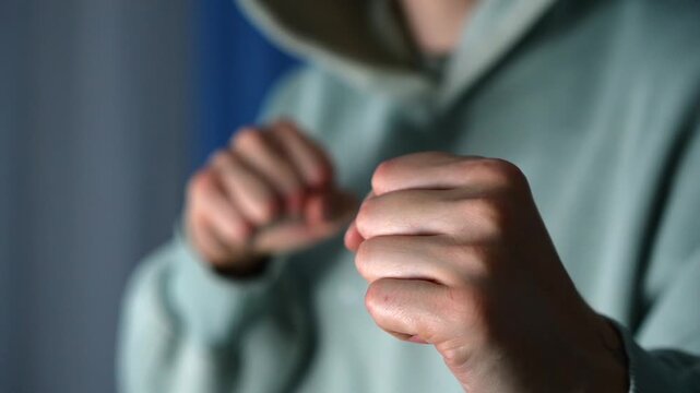 A man with clenched fists.
An abusive man clenches his fists before hitting someone.
The man provoked the conflict.
An angry man swings his fists.