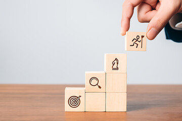 Business strategy success steps concept wooden blocks with target search and goal achievement symbol