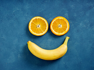 Citrus and banana fruit creating happy smiling face