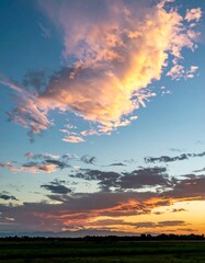 Vibrant sunset cloudscape over a field
