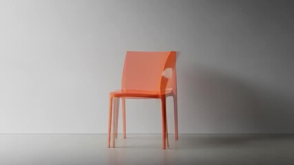 Bright orange modern chair positioned against a minimalist gray wall, showcasing sleek design and simplicity