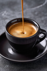 Indulge in Rich Espresso Delight: Perfect Coffee Pour in Stylish Black Cup for your Morning Ritual, Cafe Menu, or Coffee Lover's Blog, a great start to your day with Coffee