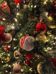 Close-up of a decorated Christmas tree with sparkling ornaments and warm lights. Festive and cozy holiday atmosphere symbolizing Christmas celebration, family traditions, and winter mood.