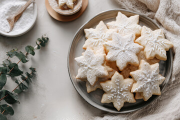 Top view of Christmas star cookies with white icing on a tray. Festive homemade cookies, traditional holiday dessert.