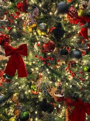 Close-up of a decorated Christmas tree with sparkling ornaments and warm lights. Festive and cozy holiday atmosphere symbolizing Christmas celebration, family traditions, and winter mood.