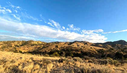 Vast landscape, golden hills under a clear sky