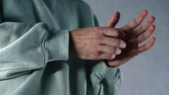 A man scratches his palm.
An itchy palm could be due to an allergy or an insect bite.
A man's palm, close-up.