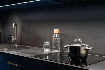 Modern blue kitchen cabinet with stylish appliances in contemporary apartment