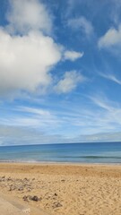 Fototapeta premium ocean, sea, waves, blue, rocl, day, beach, coast, coastline, island, porto santo island, peace, travel, tourism, destination, portugal, europe, nature, landscape, sun, sunset, clouds, cliff, mountain