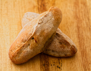 Rustic Loaves of Freshly Baked Bread on Wooden Surface