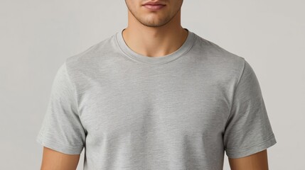 Close-up of a Person Wearing a Plain Gray T-shirt on a Neutral Background