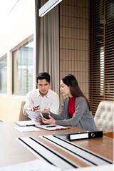 Two Asian businessman talk, consult, discuss working with new startup project idea presentation...