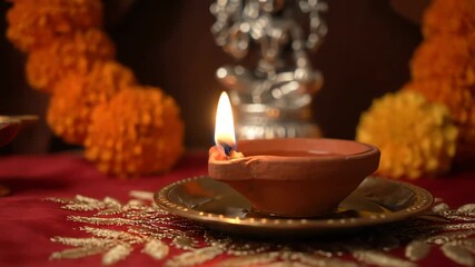 Karaka Chaturthi : Sacred Hindu Puja Ceremony with Glowing Diya Lamp and Marigold Flowers for Diwali Festival - Powered by Adobe