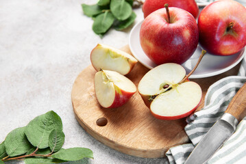 Fresh red apples slicing on wooden board