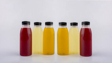 Fruit juice in a clear bottle on a white background