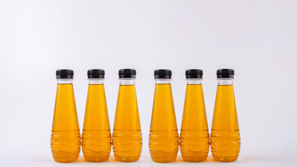 Fruit juice in a clear bottle on a white background