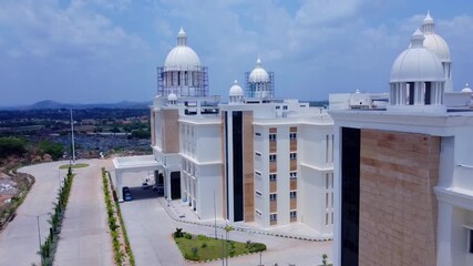 Aerial tracking shot of a grand building with large white domes under construction. Neoclassical architecture for a university or government building. - Powered by Adobe