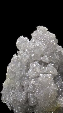 White Zincite Crystals (ZnO2 - zinc dioxide) from Silesia, Poland, rotating slowly against a black background. Vertical