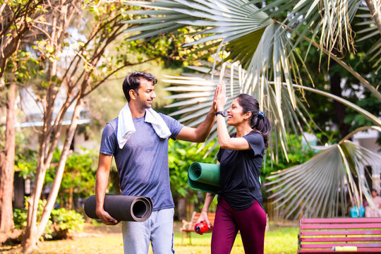 Fototapeta Indian beautiful young couple high five after yoga enjoying morning fitness outdoors