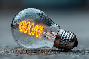 Creative Innovation Concept with Glowing Light Bulb on Textured Surface